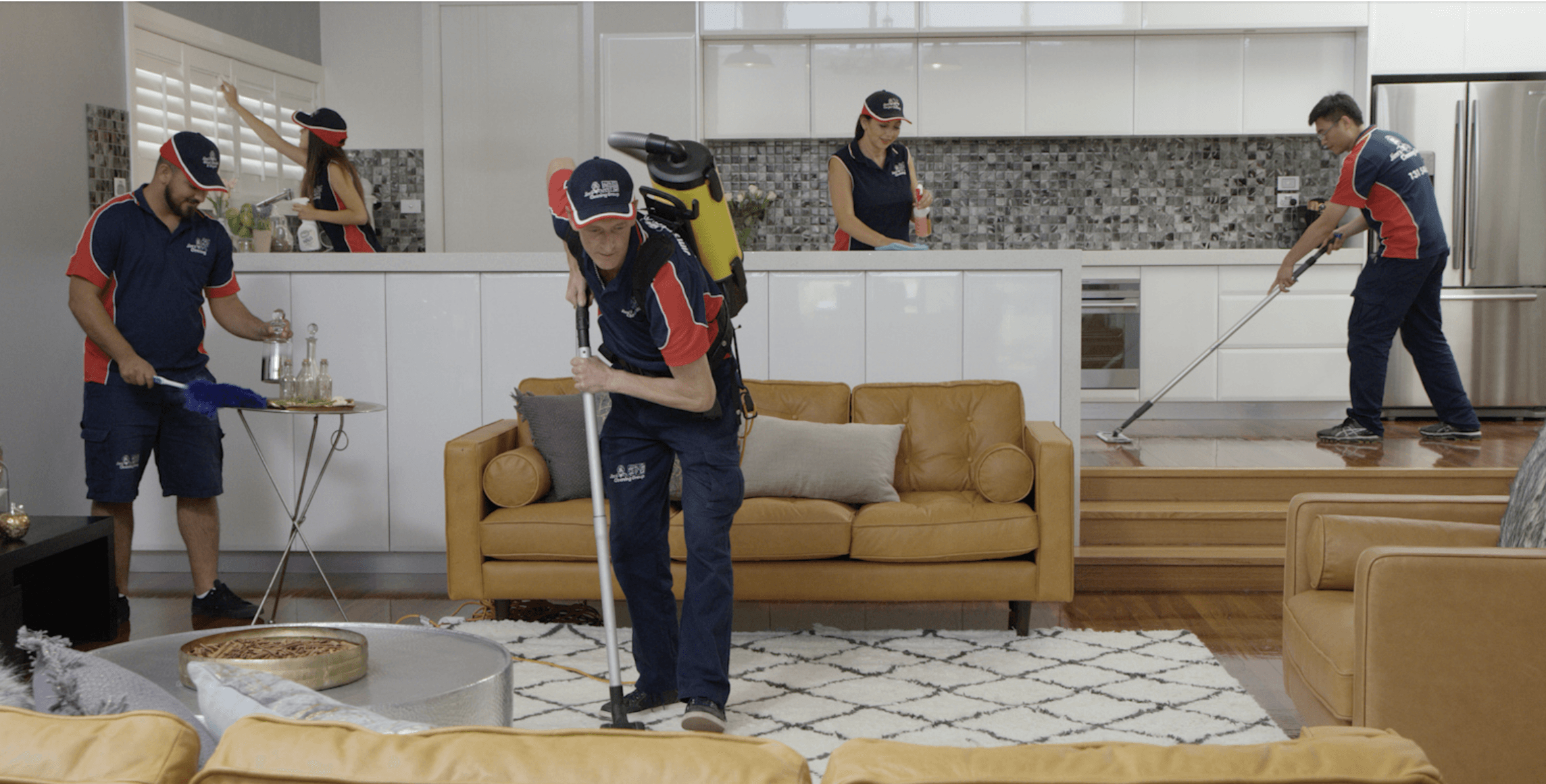 Jim’s Cleaning team dusting, vacuuming and mopping a home
